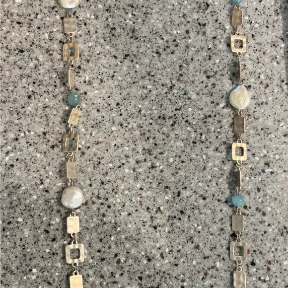 Long, silver tone geometric shape necklace with aqua accents. - Picture 2 of 3